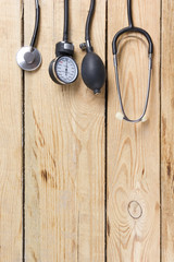 Workplace of a doctor. Medical clipboard and stethoscope on wooden desk background. Top view