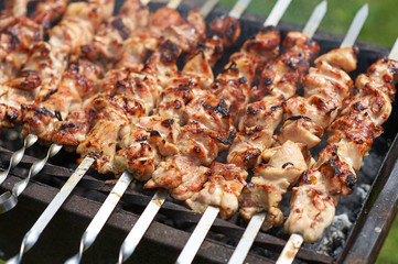 Grilling shashlik on barbecue grill with delicious meat