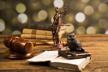 Golden scales of justice, books, Statue of Lady Justice. Owl and paragraph