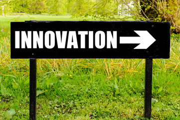 INNOVATION written on directional black metal sign