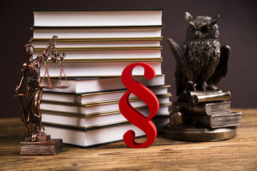 Golden scales of justice, books, Statue of Lady Justice. Owl and paragraph