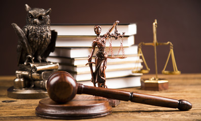 Golden scales of justice, books, Statue of Lady Justice. Owl and paragraph