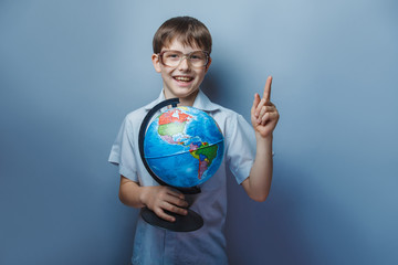 a boy of 10 years of European appearance with glasses holding a 