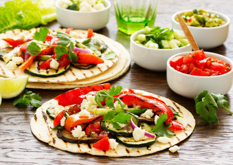 Vegetarian snack tacos with grilled vegetables and salsa.