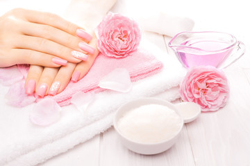 Fototapeta na wymiar french manicure with essential oils, rose flowers. spa