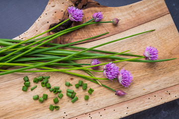Bunch of fresh chives on a wooden table