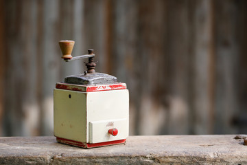 Hand-operated old wooden coffee or spices grinder