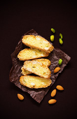 Italian cookies (biscotti) with almonds and pistachios. Selective focus.