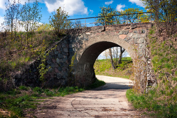 Fototapeta na wymiar Railroad Stone Bridge over the road