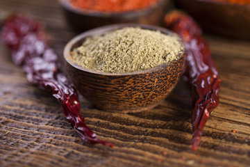 Spices and herbs in wooden bowls