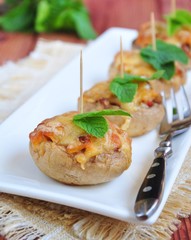 Mushrooms stuffed with vegetables and cheese. selective focus.