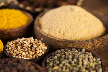 Spices and herbs in wooden bowls