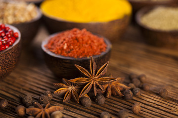 Spices and herbs in wooden bowls