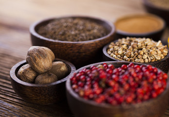 Spices and herbs in wooden bowls