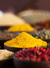 Spices and herbs in wooden bowls