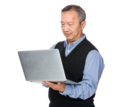 Asian Mature Man Use Of Notebook Computer