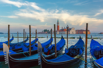 Fototapeta na wymiar Gondolas at twilight in Venice lagoon, Italia