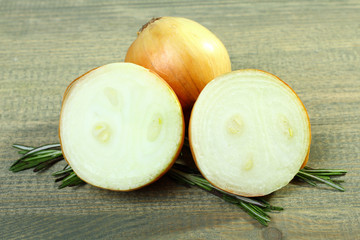 onion and rosemary on the wooden background