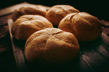 Homemade bread freshly baked and served on vintage wooden board