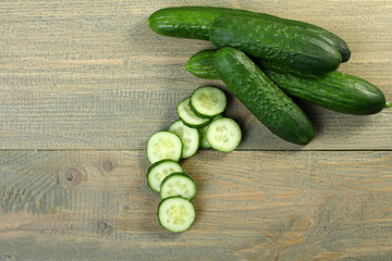 Fresh cucumbers on a wooden background