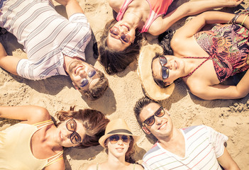 group of friends lying on the beach
