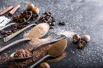 Chocolate powder cocoa and coffee spoons on the table