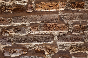 Brick wall background. Artistic and dramatic view of a brick wall using lights and shadows, customizable background.