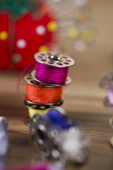 Sewing kit. Colored thread, pins, buttons, ribbons, safety pin.