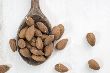 almonds, white wooden table background