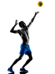 Obraz na płótnie Canvas man playing beach volley silhouette