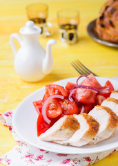 Grilled chicken breasts with fresh tomato salad