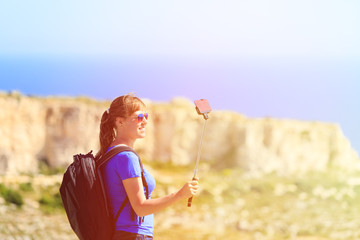 Fototapeta premium tourist making selfie photo on mountains travel