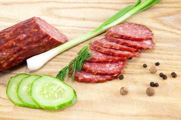 salami sausages on wooden board isolated