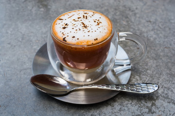 Thai tea served in a glass with cream
