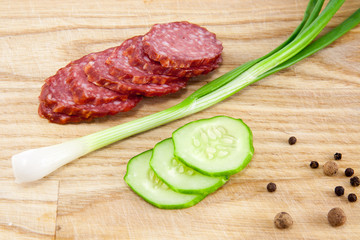 salami sausages on wooden board isolated
