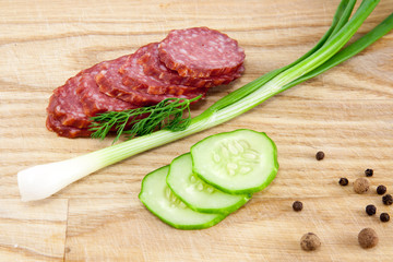 salami sausages on wooden board isolated