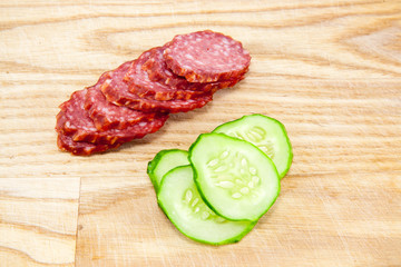 salami sausages on wooden board isolated