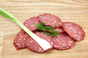 salami sausages on wooden board isolated