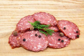 salami sausages on wooden board isolated