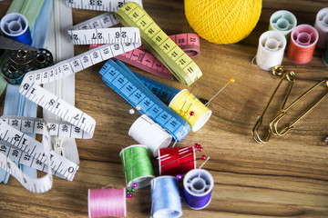 Sewing with color threads, meter and scissors