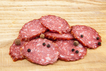 salami sausages on wooden board isolated