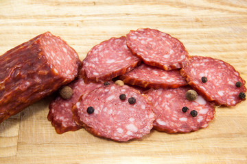 salami sausages on wooden board isolated