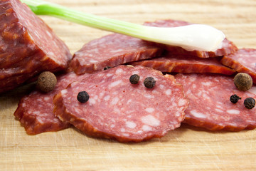 salami sausages on wooden board isolated
