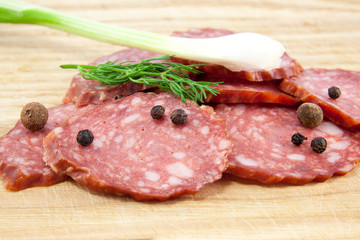salami sausages on wooden board isolated
