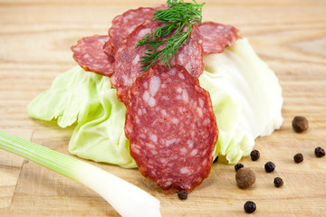 salami sausages on wooden board isolated
