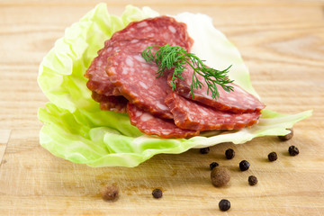 salami sausages on wooden board isolated