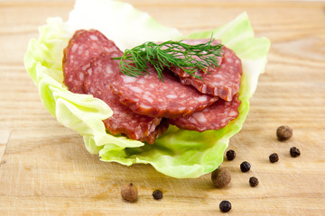 salami sausages on wooden board isolated