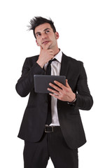 Thoughtful businessman with tablet