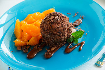 Chocolate ice cream in chocolate chips and oranges.