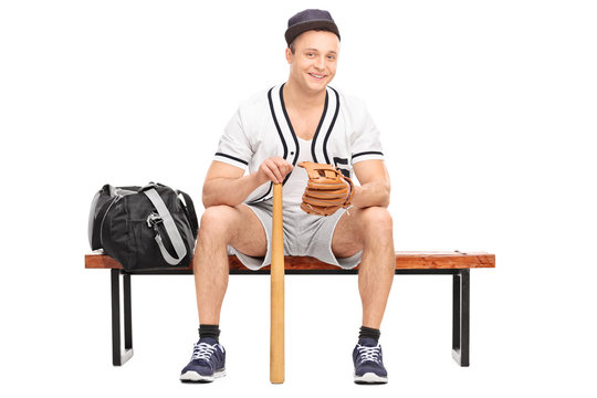 Young baseball player sitting on bench
